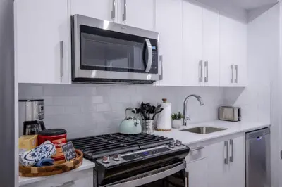a kitchen with a stove and a microwave at 431 Frontier in Calgary