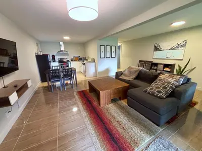 a living room with a couch and a table at Coastal Drift Sooke in Sooke
