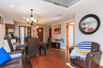 a living room with a table and a dining room at Evergreen at Solara Resort in Canmore