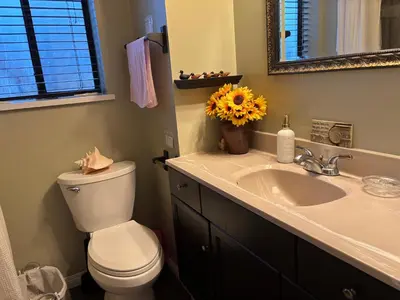a bathroom with a toilet and a sink and a mirror at Warm new Jayco trailer with comfy queen bed in Aldergrove