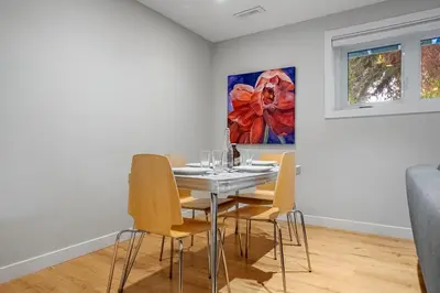 a dining room with a table and chairs at Entire Home - 2 Separate Units in Calgary