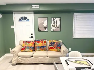 a living room with a couch with colorful pillows at Vancouver UBC 3BD Garden Suite in Vancouver