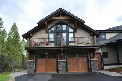 a house with a balcony on top of it at Radium Elk Park B & B in Radium Hot Springs