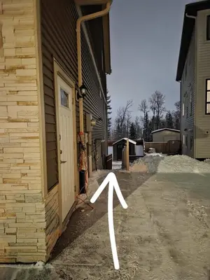 a door on a house with a arrow pointing to the side at Modern 2 Bedroom Suite Private & Fully Furnished in Prince George