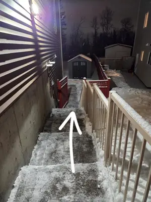 a snowy stairway with a white arrow pointing up at Modern 2 Bedroom Suite Private & Fully Furnished in Prince George