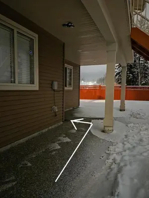 an empty parking lot next to a house at Modern 2 Bedroom Suite Private & Fully Furnished in Prince George