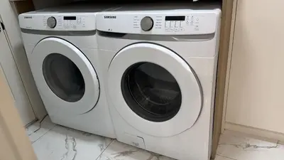a white washer and dryer sitting in a room at Vancouver Downtown Apartment - Walk to SkyTrain & BC Place, Free Parking in Vancouver