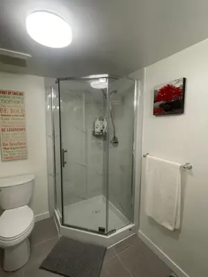 a bathroom with a glass shower with a toilet at 4615 Inverness Street Vancouver King And Queen size 2 Bedrooms Suite with Private Entry in Vancouver