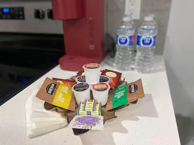 a tray of food on a counter with cups of coffee at Modern 2BR Suite with Private Yard in Calgary