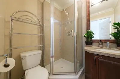 a bathroom with a shower and a toilet and a sink at Cozy Room with Private Washroom in Central Location in Vancouver