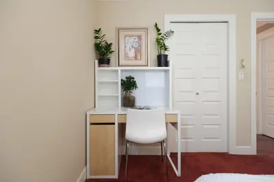 a white desk with a white chair in a room at Cozy Room with Private Washroom in Central Location in Vancouver