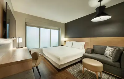 a hotel room with a bed and a couch at Hyatt Place Vancouver/Metrotown in Burnaby