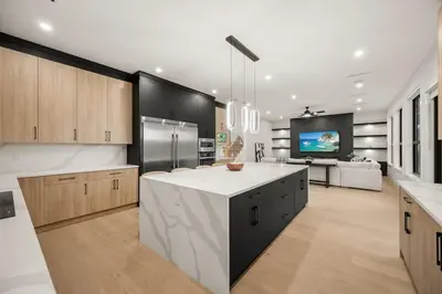 a large kitchen with a large island in the middle at Luxury 5BR Modern Home Huge Open Layout in Langley