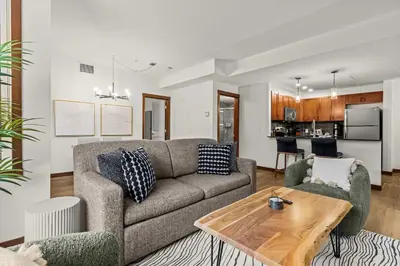 a living room with a couch and a table at Modern 1 Bedroom Retreat with Sofa Bed Comfort & Convenience Combined in Canmore