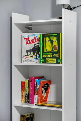 a book shelf filled with childrens books at 1BR Entertainment Space Projector and Games Room in Airdrie