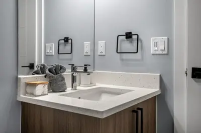 a bathroom with a sink and a mirror at 1BR Entertainment Space Projector and Games Room in Airdrie