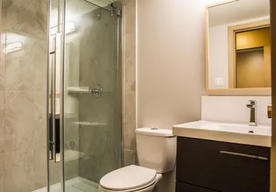 a bathroom with a shower and a toilet and a sink at Fox Creek Inn in Fox Creek