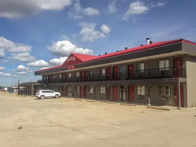 a building with a car parked in front of it at Fox Creek Inn in Fox Creek
