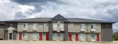a building with a sign on the top of it at Fox Creek Inn in Fox Creek