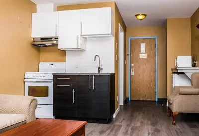 a kitchen with a sink and a stove at Fox Creek Inn in Fox Creek