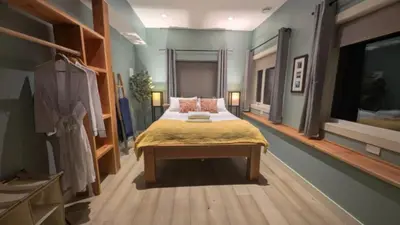 a bedroom with a large bed in a room at 'The Lookout' Sea View Suite w Hot tub in Shirley