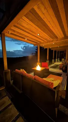 a porch with a couch and a table with a view at 'The Lookout' Sea View Suite w Hot tub in Shirley