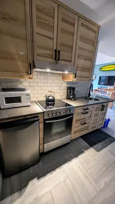 a kitchen with stainless steel appliances and wooden cabinets at 'The Lookout' Sea View Suite w Hot tub in Shirley
