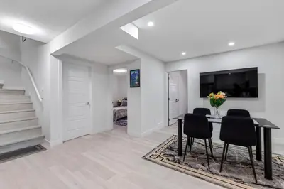 a dining room with a table and chairs at Brand New 3 Bedroom, 2 Washroom, Kitchen and Ensuite in Chestermere