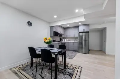 a kitchen with a table and chairs in a room at Brand New 3 Bedroom, 2 Washroom, Kitchen and Ensuite in Chestermere