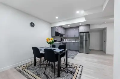 a kitchen and dining room with a table and chairs at Brand New 3 Bedroom, 2 Washroom, Kitchen and Ensuite in Chestermere