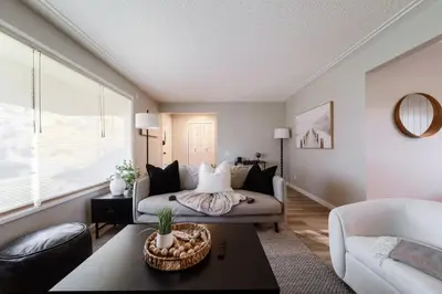 a living room with a couch and a table at Newly Renovated, Bright & Cozy 3 bdrm Home - 6min from Rogers Arena in Edmonton