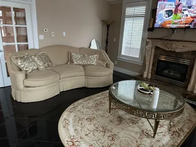 a living room with a couch and a coffee table at Cozy & Equipped Room Right Next to Mall & Skytrain in Vancouver
