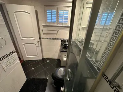 a small bathroom with a toilet and a window at Luxury Room with Private Washroom in Prime Location in Vancouver