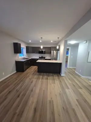 an empty kitchen and living room of a apartment at Whitehorse Guest Stay in Whitehorse