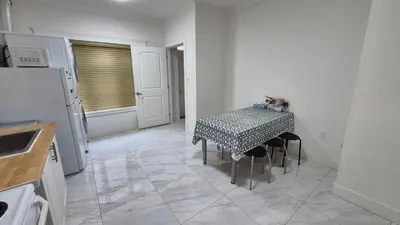 a kitchen with a table with a polka dot table cloth at Entire ground floor 2 Baths 3 Beds Full Privacy in Vancouver
