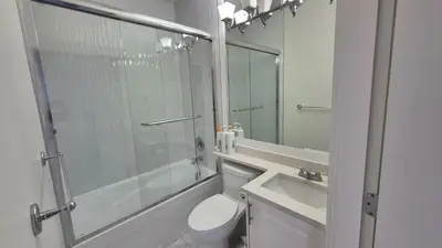 a bathroom with a shower and a toilet and a sink at Entire ground floor 2 Baths 3 Beds Full Privacy in Vancouver