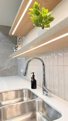 a kitchen sink with a faucet on a counter at Canmore Peaks Retreat | Luxe 1BR w Pool & Gym in Canmore