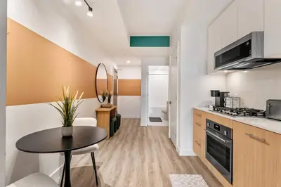 a kitchen with a table and a counter top at Incredible DT Views| King bed| Rest and Unwind in Calgary