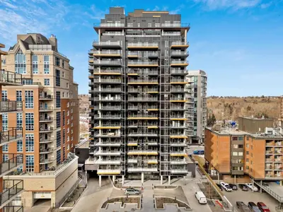 an apartment building with balconies in a city at Incredible DT Views| King bed| Rest and Unwind in Calgary