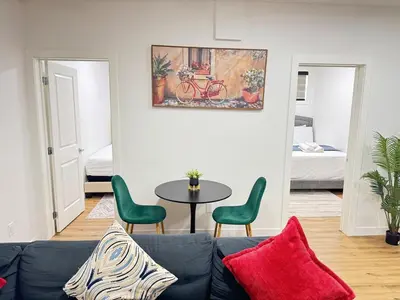 a living room with a couch and a table at Stylish and Cozy 2-Bedroom Guest Suite in West Edmonton in Edmonton