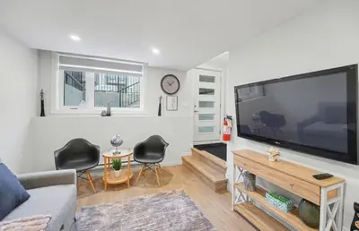 a living room with a large flat screen tv at Luxury brand new 1 Bedroom Townhome in Calgary