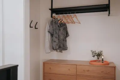 a room with a wooden dresser and a closet at Gary's Birthday by Revelstoke Vacations in Revelstoke
