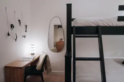 a bedroom with a desk and a bunk bed with a mirror at Gary's Birthday by Revelstoke Vacations in Revelstoke