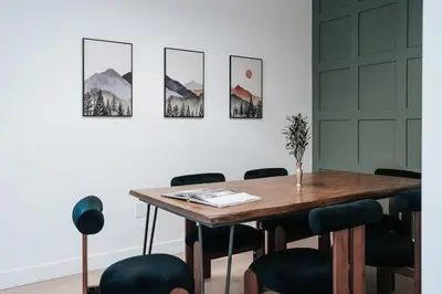 a dining room with a wooden table and chairs at Cloudscape Penthouse by Revelstoke Vacations in Revelstoke