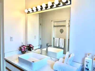 a bathroom with two sinks and a large mirror at 2BR sweet suite in Nanaimo