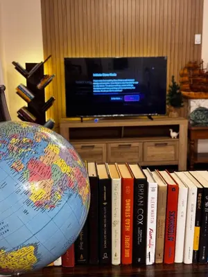 a globe sitting on a table next to books at 2BR sweet suite in Nanaimo