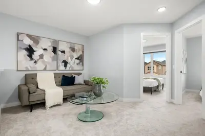 a living room with a couch and a table at Modern 4BR Retreat 3 Baths Near to Banff&Airport in Calgary