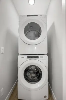 a white washer and dryer in a laundry room at Modern 4BR Retreat 3 Baths Near to Banff&Airport in Calgary