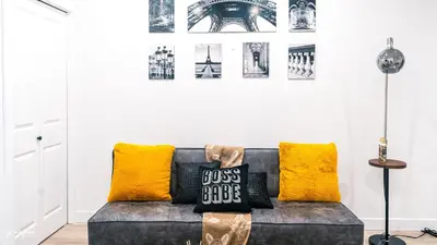 a living room with a couch with yellow pillows at Ebenz Apartment in Calgary