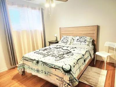a bedroom with a bed and a window at House in Edmonton